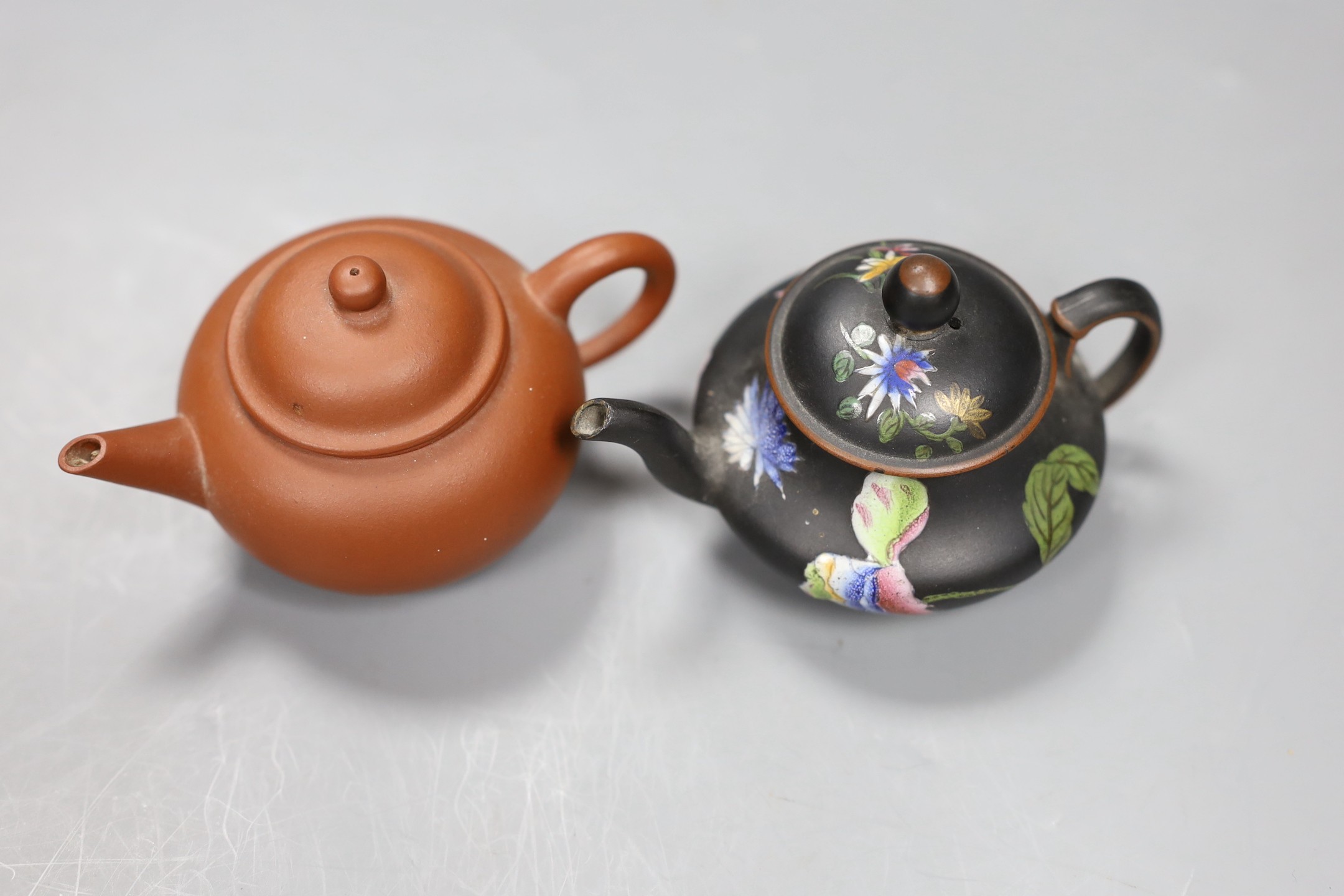 A Chinese Yixing miniature teapot and a Wedgwood enamelled black basalt miniature teapot, 6cm high